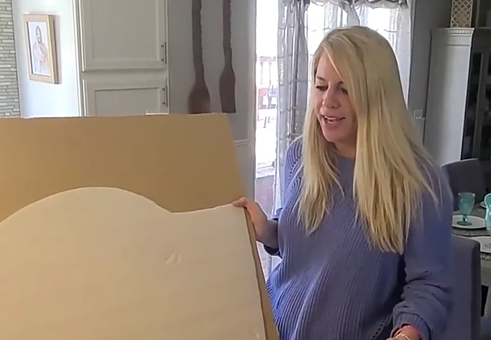 Customer holding the custom neon sign backing during unpacking