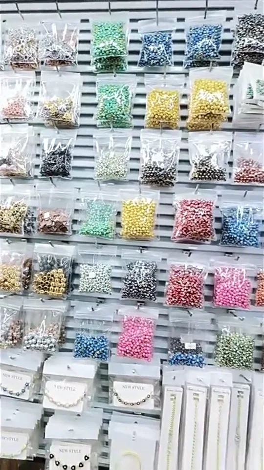 Supplier wall displaying individually packed DIY jewelry components