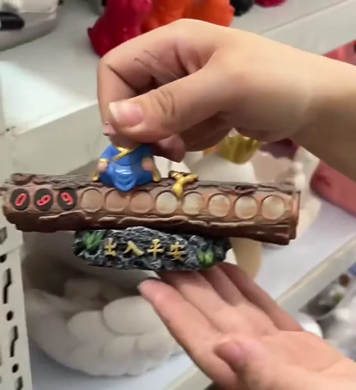Craft worker hand-painting details on a resin ornament